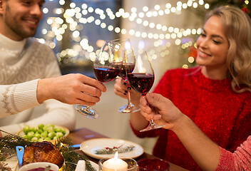 Image showing close up of friends with wine celebrate christmas