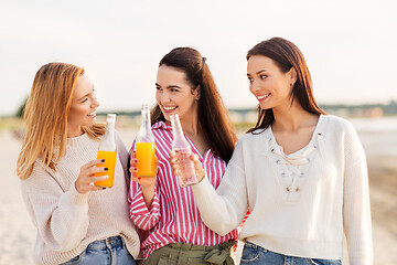 Image showing young women toasting non alcoholic drinks on beach