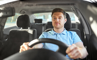 Image showing man or driver with wireless earphones driving car