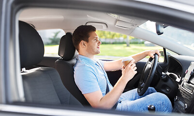 Image showing man or driver with takeaway coffee cup driving car