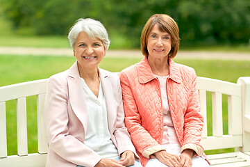 Image showing senior women or friends sitting on bench at park