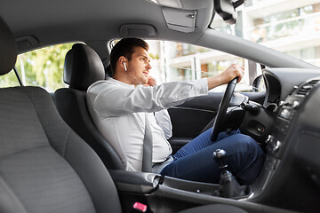 Image showing man or driver with wireless earphones driving car