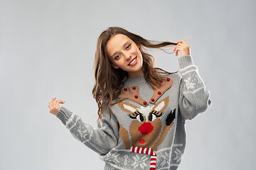 Image showing woman in christmas sweater with reindeer pattern