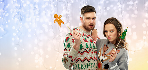 Image showing couple with christmas party props in ugly sweaters