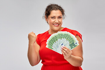 Image showing happy woman holding hundreds of money banknotes