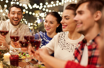 Image showing friends celebrating christmas and drinking wine