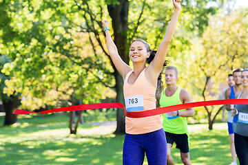 Image showing happy young female runner on finish winning race