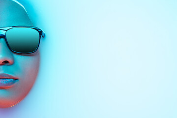 Image showing Beautiful female face in the milk bath with soft glowing in blue-pink neon light