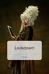 Image showing Medieval young woman in old-fashioned costume with tablet behing the message with word Lockdown