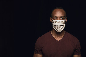 Image showing Man wearing protective face mask with sign masks for 100 days in USA, America
