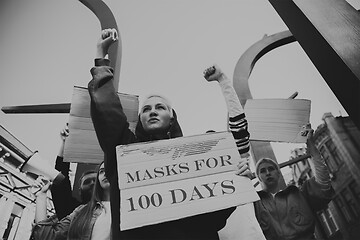 Image showing Group of activists protesting, supporting masks for 100 days in America. Look angry, hopeful, confident. Banners and smoke. Coronavirus.