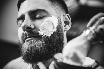 Image showing Client during beard shaving in barber shop