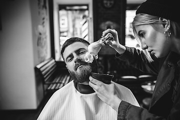 Image showing Client during beard shaving in barber shop