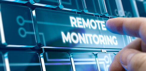 Image showing Remote Monitoring - Man Pushing Button on Futuristic Interface.