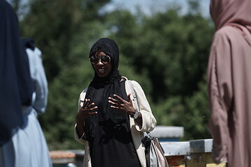 Image showing woman giving presentation to group of business investors on local honey production farm