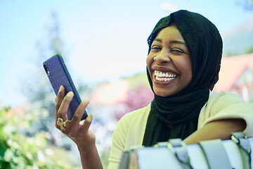 Image showing african woman using smartphone wearing traditional islamic clothes
