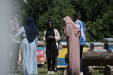 Image showing woman giving presentation to group of business investors on local honey production farm