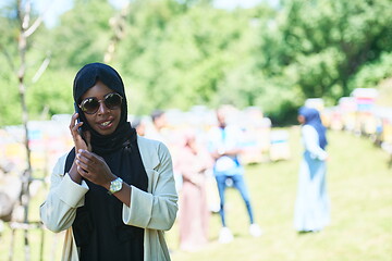 Image showing african woman using smartphone wearing traditional islamic clothes