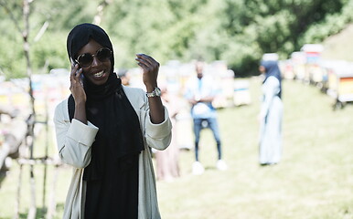 Image showing african woman using smartphone wearing traditional islamic clothes