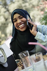 Image showing african woman using smartphone wearing traditional islamic clothes