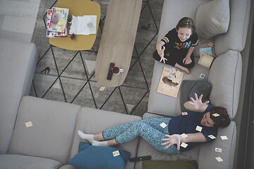 Image showing mother and daughter at home playing memory game