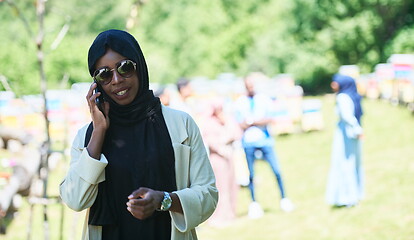 Image showing african woman using smartphone wearing traditional islamic clothes