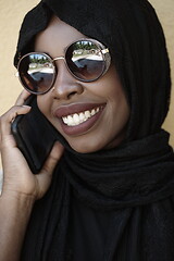 Image showing african woman using smartphone wearing traditional islamic clothes