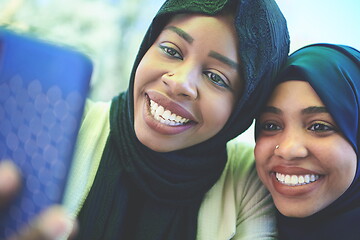 Image showing african female friends using smart phone together