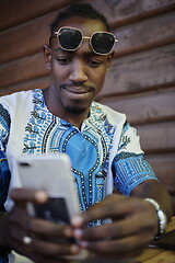 Image showing native african black man using smart phone