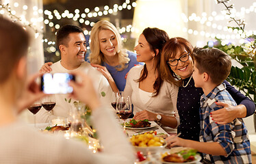 Image showing family having dinner party and taking selfie