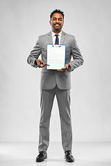 Image showing indian businessman with contract on clipboard