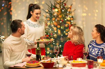 Image showing happy friends having christmas dinner at home