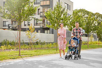 Image showing family with baby in stroller and coffee in city