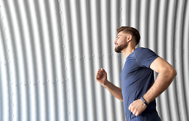 Image showing sporty young man running in tunnel