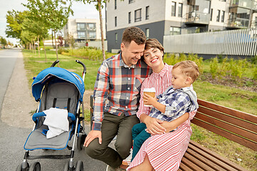 Image showing family with baby in stroller and coffee in city
