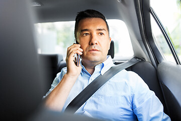 Image showing male passenger calling on smartphone in taxi car