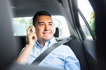 Image showing passenger in headphones listening to music in car