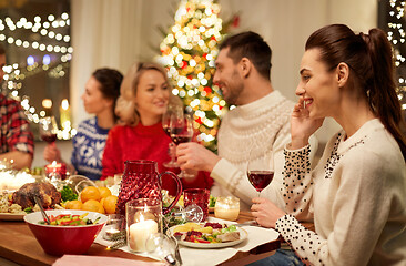 Image showing happy friends having christmas dinner at home