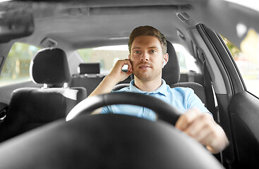 Image showing man or driver with wireless earphones driving car