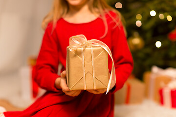 Image showing close up of girl with christmas gift at home