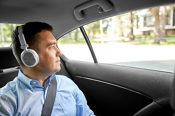 Image showing passenger in headphones listening to music in car