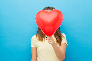 Image showing woman covering face with heart-shaped balloon