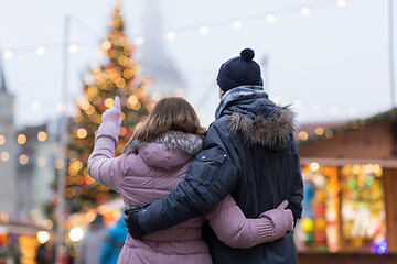 Image showing happy senior couple hugging at christmas market