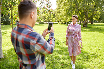 Image showing couple photographing by smartphone in park