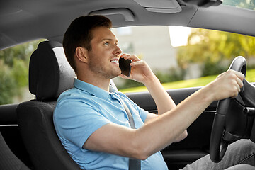 Image showing man driving car and calling on smartphone