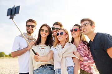 Image showing happy friends taking selfie on summer beach