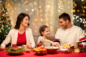 Image showing happy family having christmas dinner at home