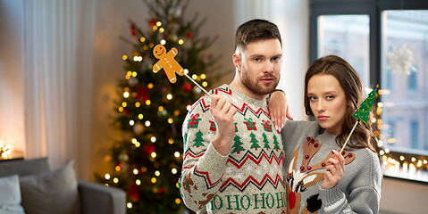 Image showing couple with christmas party props in ugly sweaters