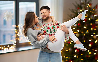 Image showing happy couple at christmas ugly sweater party
