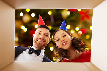 Image showing couple in party hats opening birthday gift box